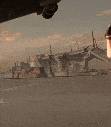 a person with a backpack is standing in front of a destroyed building