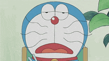 doraemon is sitting in a chair with a pencil in his hand