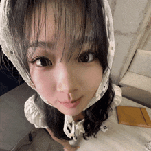 a close up of a girl wearing a white headband