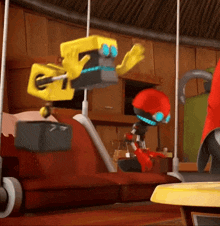 a yellow robot with blue eyes is hanging from a rope in a room