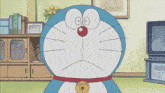 a cartoon of doraemon with a bell around his neck making a sad face