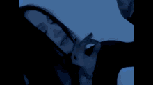 a woman in a black dress is walking in a dark room