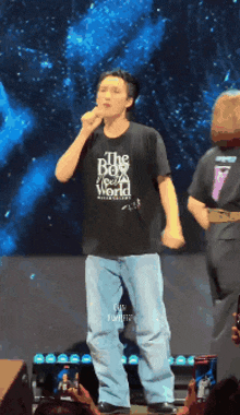 a man wearing a black shirt that says the best world