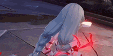 a girl with long blue hair is sitting on the ground with her head down .