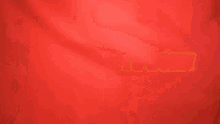 a blurry picture of two people dancing in front of a red wall