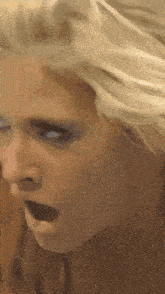 a close up of a woman with her mouth open