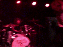 a drummer playing a drum set with a sticker on it that says ' drums ' on it