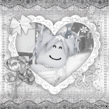a black and white photo of a heart shaped frame with a smiley face in it