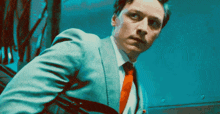a man in a suit and tie is looking up at something