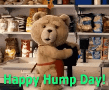 a teddy bear in an apron is hugging another teddy bear in a grocery store .