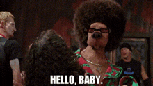 a dog with an afro and glasses is talking to a woman in a crowd and saying hello baby .