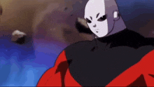 a man in a red and black costume is holding his fist up in a fist .