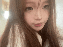 a close up of a girl 's face with long hair