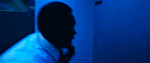 a blurry picture of a person in a blue room with the word bishop on the bottom right