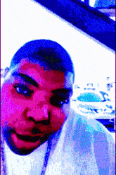 a man is wearing a white shirt and a necklace
