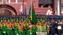 a group of soldiers marching in front of a building with a flag that says ' russia ' on it