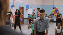 a man wearing a nyc hat is standing in a gym
