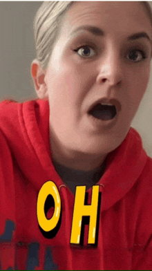 a woman wearing a red hoodie with the letters oh on her chest