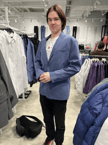 a man wearing a blue jacket and a white shirt that says tommy hilfiger