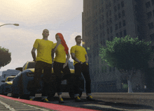 three people wearing yellow shirts are standing next to a car