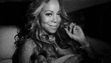 a black and white photo of a woman with long hair smiling