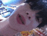 a close up of a person 's face next to a sign that says labe fe