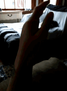 a person 's hand is visible in a dark room