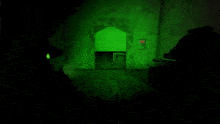 a dark room with a green light on the wall