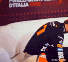 a man is kneeling down in front of a sign that says " ditalia "