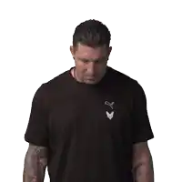 a man with tattoos on his arms is clapping his hands in front of a white background