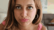a close up of a woman making a face with her mouth open .