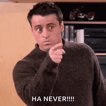 a man in a brown sweater is pointing at the camera and saying `` ha never '' .