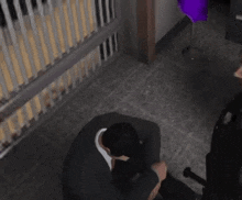 a man in a suit is kneeling down in front of a police officer in a video game