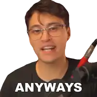 a man wearing glasses and a black shirt says anyways in front of a microphone