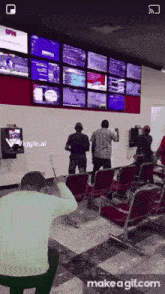a man sitting in front of a wall of monitors that says spin on it