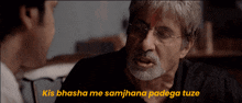 a man with glasses and a beard talks to another man with the words kis bhasha me samjhana padega tuze