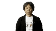 a man standing in front of a super mario logo