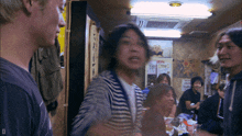 a group of people in a room with a sign that says kirin on it