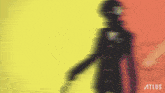 a blurred image of a person with the word atlus on the bottom right