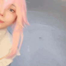 a woman with pink hair is wearing a white hat and gloves and smiling .