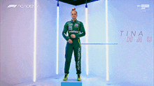 a woman in a green racing suit with the name tina hausmann on it