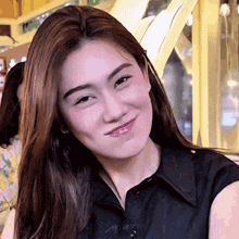 a close up of a woman 's face with a slight smile on her face .