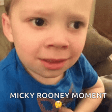 a young boy is making a funny face and says micky rooney moment