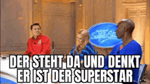 a group of people are sitting at a table with a sign that says der steht da und denkt er ist der superstar .