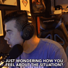 a man is wearing headphones and a dxracer chair