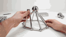 a person is playing with a set of metal balls
