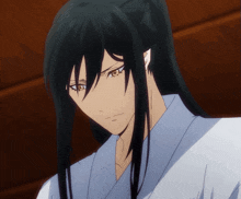 a man with long black hair and brown eyes