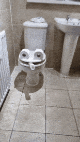 a toilet with a face made of toilet paper
