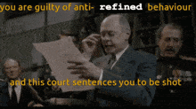 a man holding a piece of paper with the words " you are guilty of anti-refined behaviour " written above him