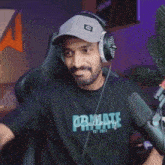 a man wearing headphones and a shirt that says private on it